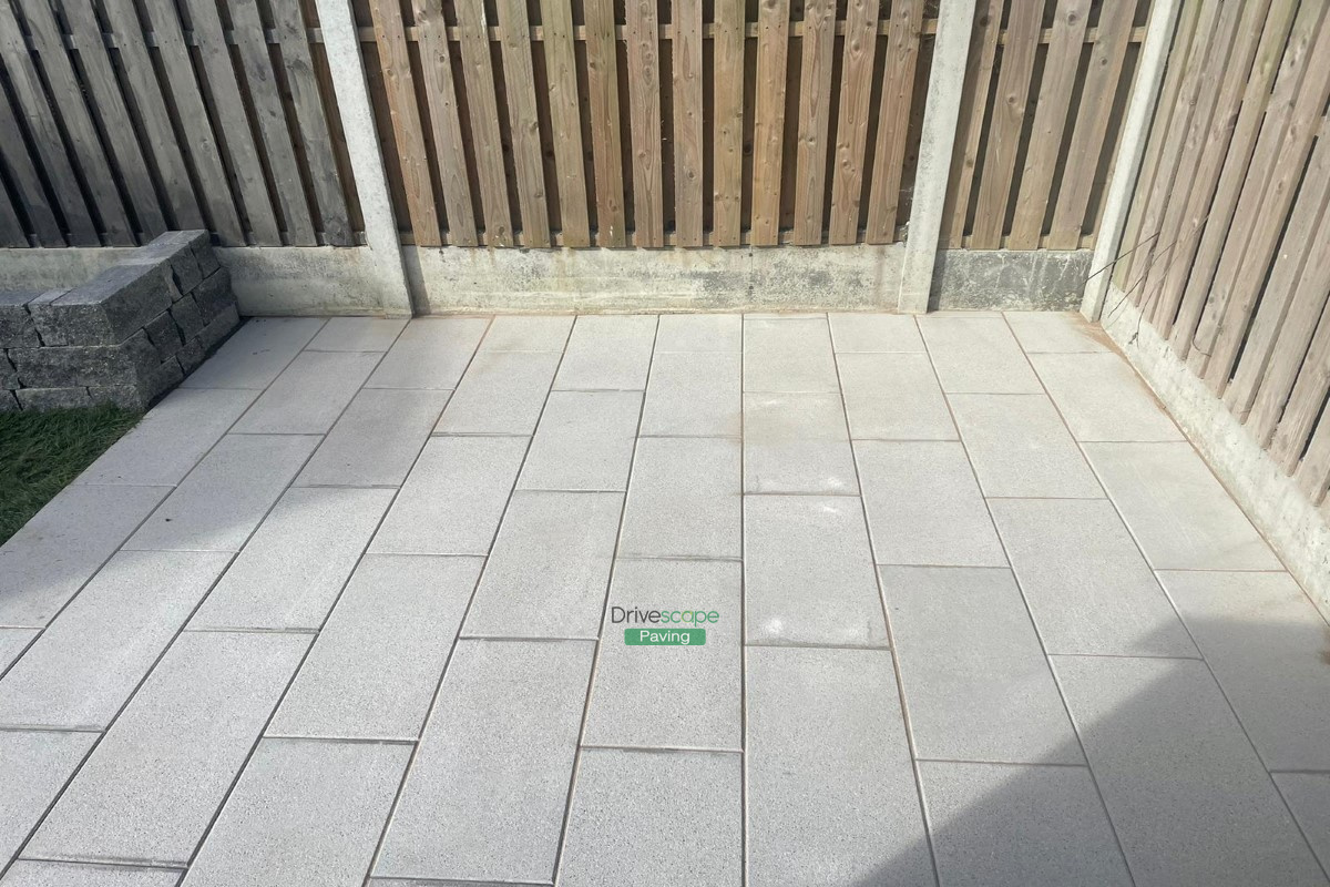 Patio with Silver Granite Slabs, Roll-On Turf and Granite Walling in ...